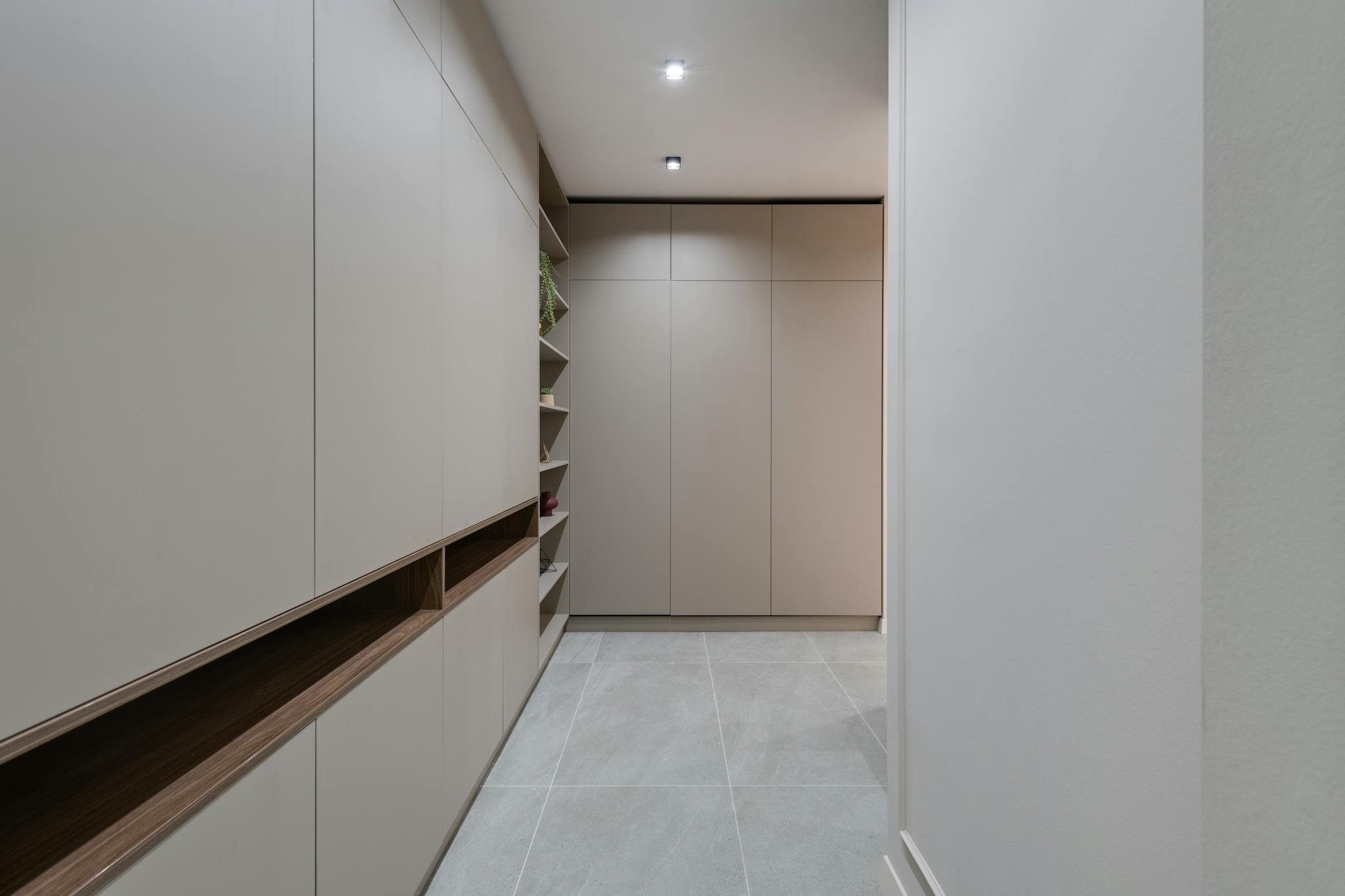Explore a contemporary minimalist hallway featuring sleek modern cabinetry and neutral colors.